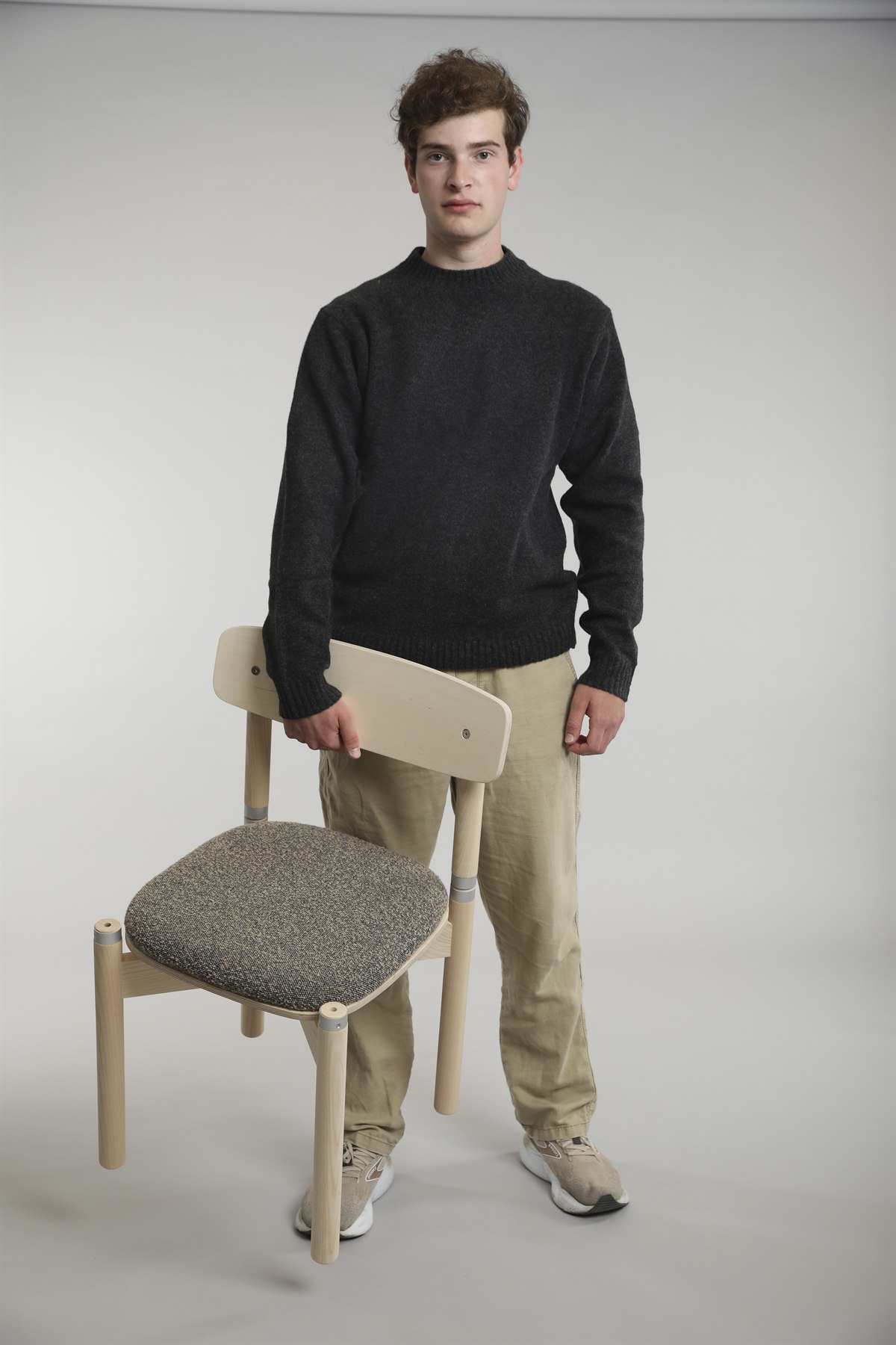 Sam Howard holding a chair he designed